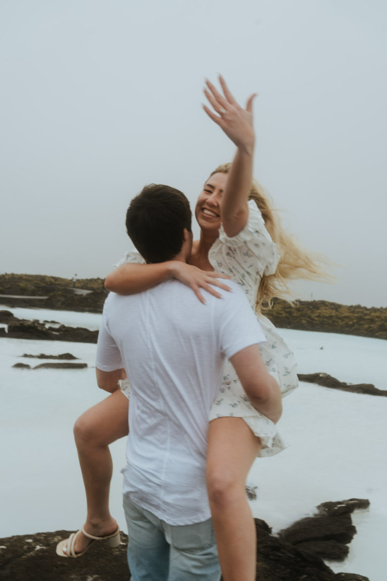 Happy fiancé showing ring to the camera in Blue Lagoon